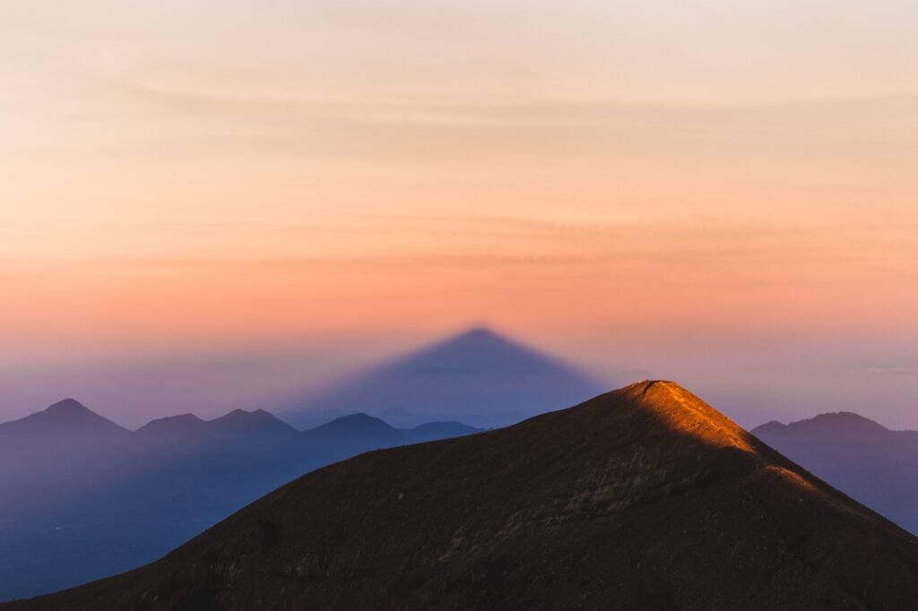 Crater rim of mount Agung in Bali at sunrise summit. Above the clouds, colorful landscape